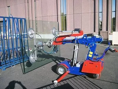 Eine blau-rote Maschine hebt ein großes Stück Glas