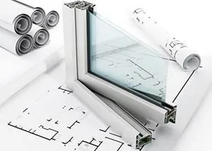 Auf einem Bauplan liegt ein Fenster.